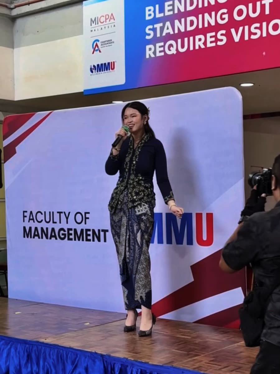 Trisha singing at an MMU Faculty of Management event